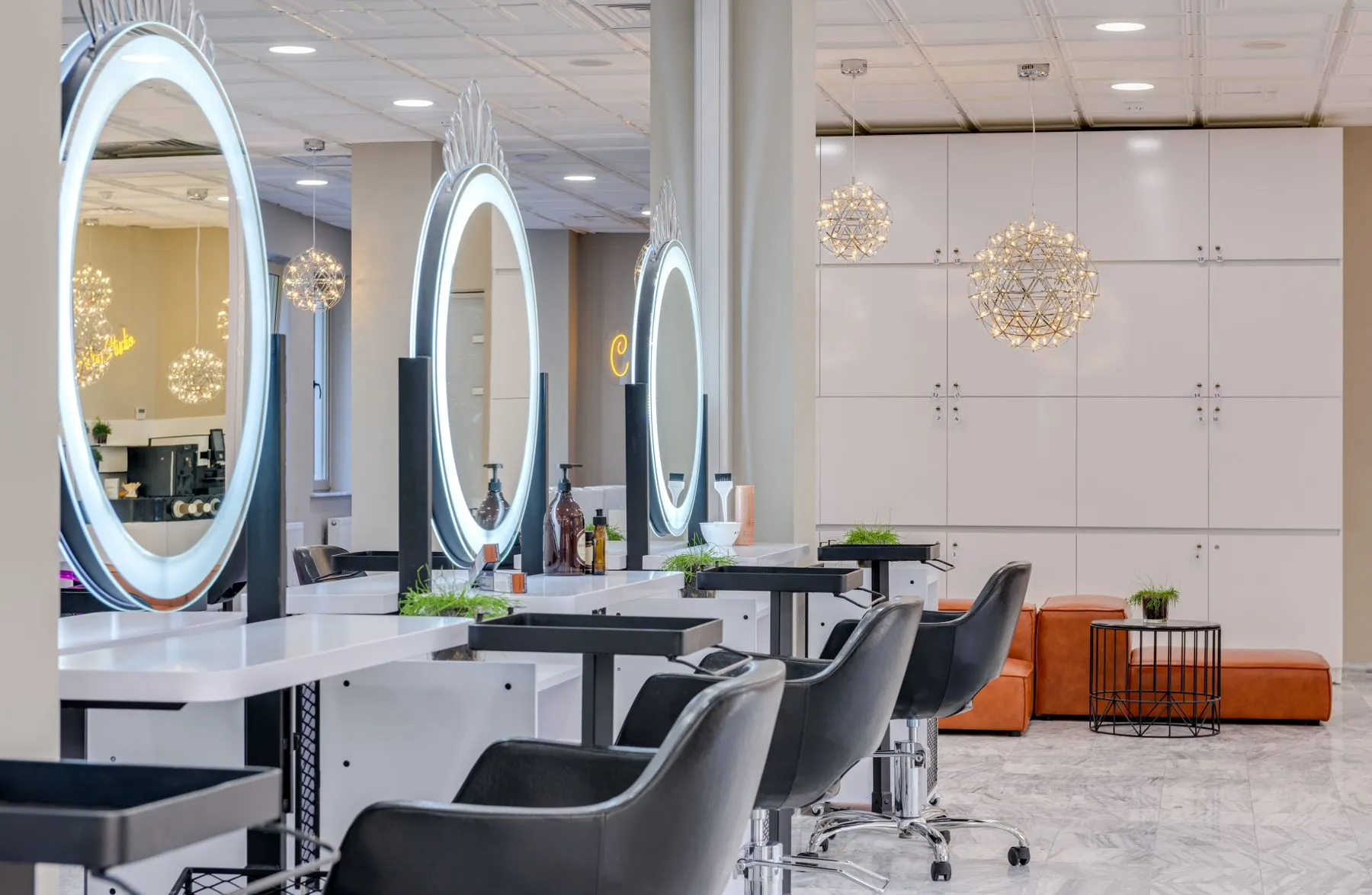 Bright salon with round mirrors and styling chairs