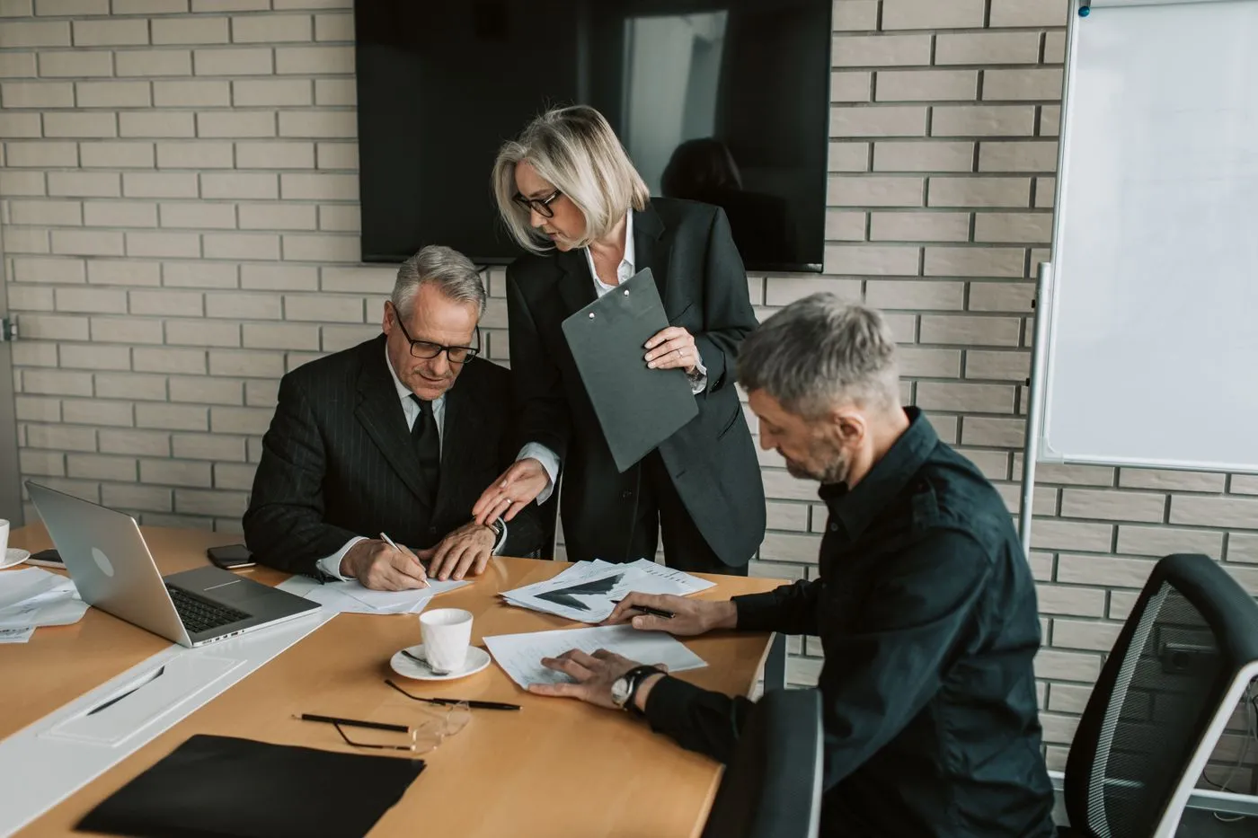 Senior advisers reviewing documents at a table