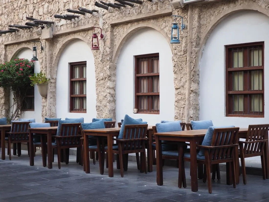 Outdoor tables in a traditional stone courtyard